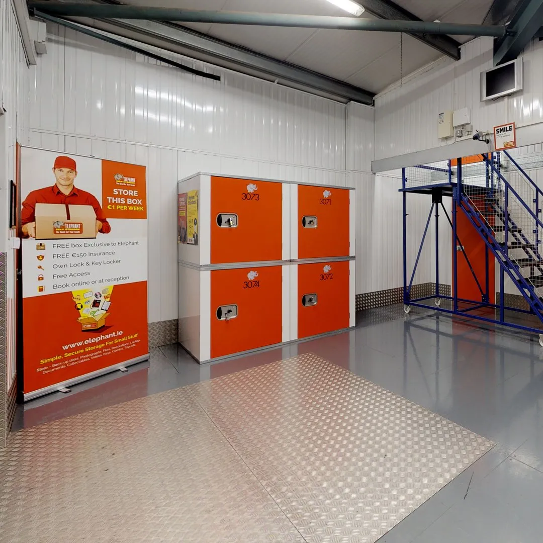 A spacious storage area filled with red and white lockers at Elephant Click & Store facilities.