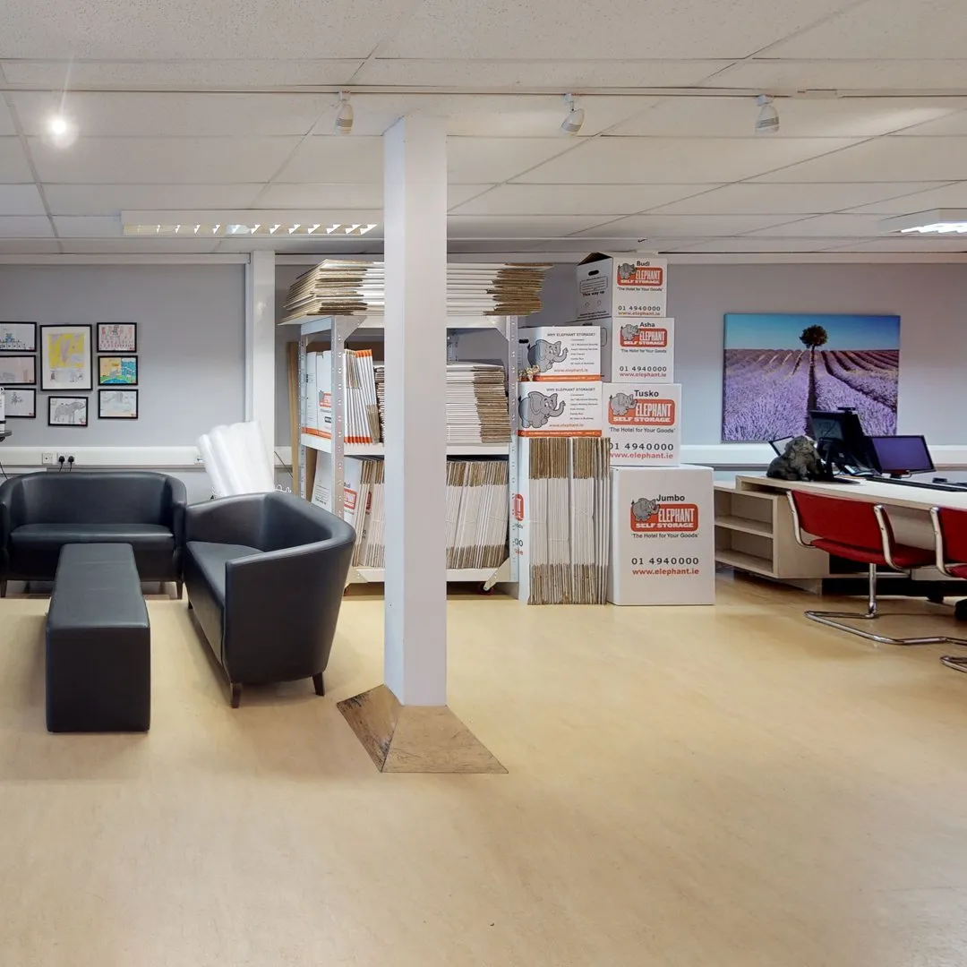 A spacious open office with a big desk and chairs at Elephant Click & Store facilities.