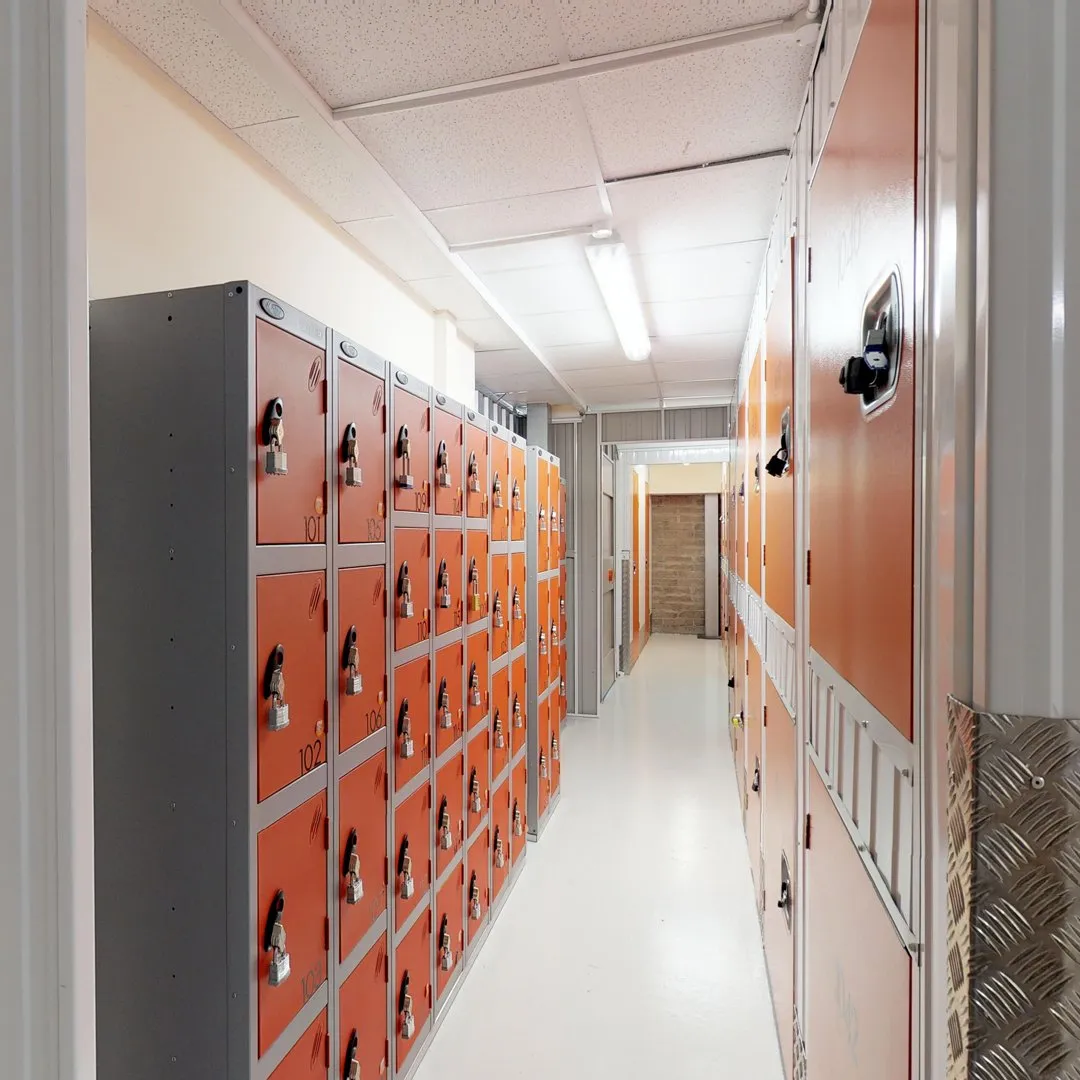 Lockers in a hallway with red and grey doors at Elephant Click & Store facilities.