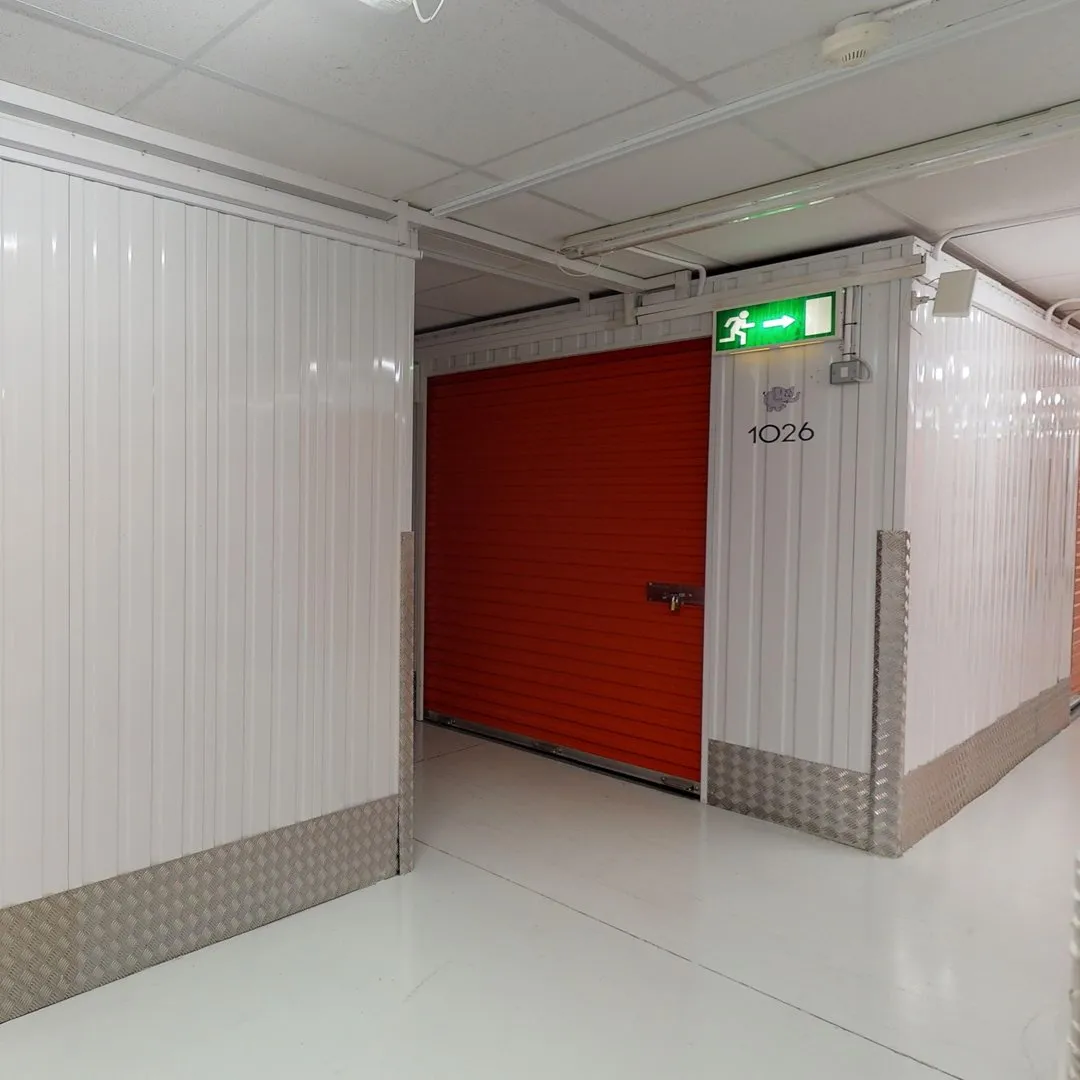 A corner with white walls and red doors at Elephant Click & Store facilities.
