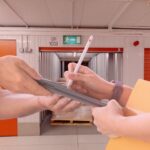 A man and woman holding a tablet in a storage unit with concierge service.