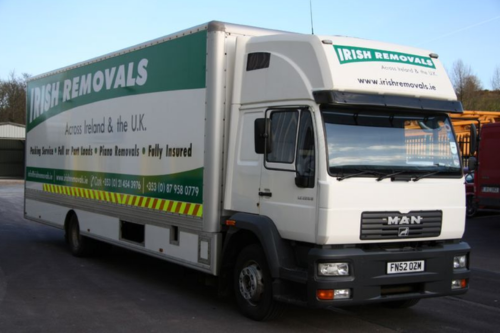 A large truck with a green and white logo on the side