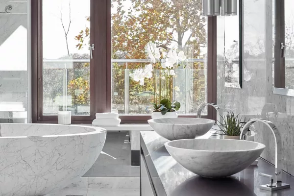 A luxurious bathroom with sleek marble countertops and a spacious tub for a contemporary feel.